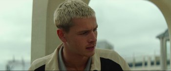 Movie still from “Scrapper” (2023), directed by Charlotte Regan – A person with white hair; Close Up shot, Low angle