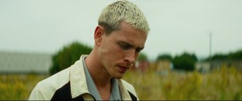 Movie still from “Scrapper” (2023), directed by Charlotte Regan – A person with white hair; Close Up shot, Low angle