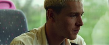 Movie still from “Scrapper” (2023), directed by Charlotte Regan – A person with blonde hair; Close Up shot, Low angle