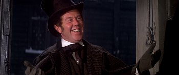 Movie still from “Scrooge” (1970), directed by Ronald Neame – A man wearing a hat and a jacket; Close Up shot, Low angle