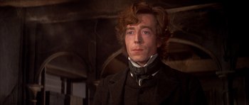 Movie still from “Scrooge” (1970), directed by Ronald Neame – A person wearing a suit and tie; Close Up shot, Low angle