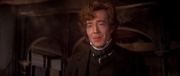 Movie still from “Scrooge” (1970), directed by Ronald Neame – A man in a black suit and a white shirt; Close Up shot, Low angle