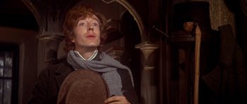Movie still from “Scrooge” (1970), directed by Ronald Neame – A young man holding a plate in his hands; Close Up shot, Low angle