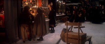 Movie still from “Scrooge” (1970), directed by Ronald Neame – A group of people standing around in the snow; Wide shot, High angle