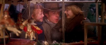 Movie still from “Scrooge” (1970), directed by Ronald Neame – A woman and two children looking out of a window; Close Up shot, Low angle