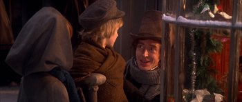 Movie still from “Scrooge” (1970), directed by Ronald Neame – A man and a boy in hats and scarves; Medium shot, Over the shoulder angle