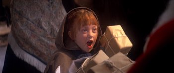 Movie still from “Scrooge” (1970), directed by Ronald Neame – A little red haired girl holding a present; Close Up shot, High angle