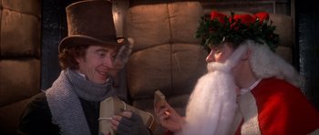 Movie still from “Scrooge” (1970), directed by Ronald Neame – A man and a woman dressed up as santa and mrs; Close Up shot, Over the shoulder angle