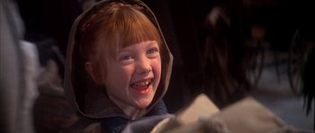 Movie still from “Scrooge” (1970), directed by Ronald Neame – A little girl with red hair and blue eyes smiling for the camera; Close Up shot, Low angle