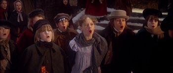Movie still from “Scrooge” (1970), directed by Ronald Neame – A group of people standing next to each other; Close Up shot, Low angle