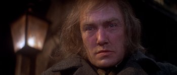 Movie still from “Scrooge” (1970), directed by Ronald Neame – An old man wearing a coat and a tie; Close Up shot, Low angle