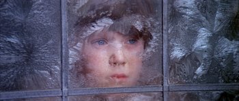 Movie still from “Scrooge” (1970), directed by Ronald Neame – A young child looking out of a frosted window; Close Up shot, High angle