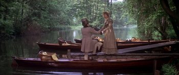 Movie still from “Scrooge” (1970), directed by Ronald Neame – A man and a woman on a boat in the water; Wide shot, High angle