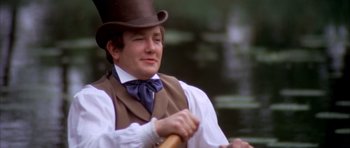 Movie still from “Scrooge” (1970), directed by Ronald Neame – A man wearing a top hat and a vest holding a baseball bat; Close Up shot, Over the shoulder angle