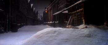 Movie still from “Scrooge” (1970), directed by Ronald Neame – A street scene with snow on the ground and buildings in the background; Extreme Wide shot, High angle