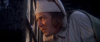 Movie still from “Scrooge” (1970), directed by Ronald Neame – A person wearing a hat; Close Up shot, Low angle