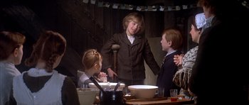 Movie still from “Scrooge” (1970), directed by Ronald Neame – A group of people sitting around a table; Medium shot, Over the shoulder angle
