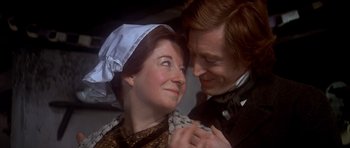 Movie still from “Scrooge” (1970), directed by Ronald Neame – A man and a woman dressed in period clothing holding hands; Close Up shot, Over the shoulder angle