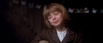 Movie still from “Scrooge” (1970), directed by Ronald Neame – A young boy wearing a jacket and a white shirt; Close Up shot, Low angle