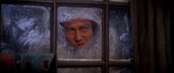 Movie still from “Scrooge” (1970), directed by Ronald Neame – A man in a white hat looking out of a window; Close Up shot, High angle