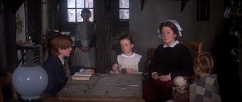 Movie still from “Scrooge” (1970), directed by Ronald Neame – A group of people sitting around a table; Medium shot, High angle