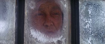 Movie still from “Scrooge” (1970), directed by Ronald Neame – An old man looking through a frosted window; Close Up shot, Low angle