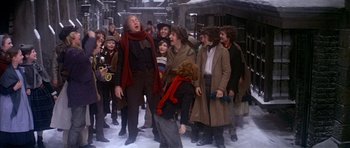 Movie still from “Scrooge” (1970), directed by Ronald Neame – A group of people standing in the middle of a street; Medium shot, Low angle