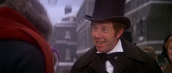 Movie still from “Scrooge” (1970), directed by Ronald Neame – A person wearing a top hat; Close Up shot, Over the shoulder angle