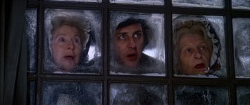 Movie still from “Scrooge” (1970), directed by Ronald Neame – A man and a woman looking through a window; Close Up shot, Low angle