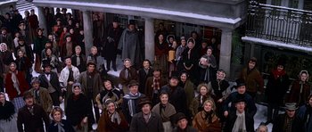 Movie still from “Scrooge” (1970), directed by Ronald Neame – A large group of people dressed in old fashion clothing; Wide shot, High angle