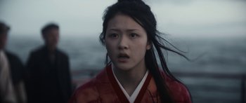 Movie still from “1899” (2022), created by Jantje Friese – A woman in a red and white kimono with long black hair; Close Up shot, Low angle