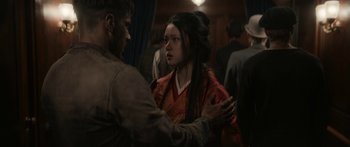 Movie still from “1899” (2022), created by Jantje Friese – A man and a woman are standing together in front of a crowd; Close Up shot, Over the shoulder angle