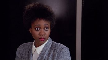 Movie still from “Scrooged” (1988), directed by Richard Donner – A woman with a surprised look on her face; Close Up shot, Over the shoulder angle