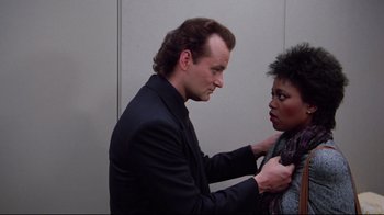 Movie still from “Scrooged” (1988), directed by Richard Donner – A man and a woman are looking at one another; Close Up shot, Over the shoulder angle