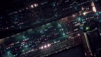Movie still from “Scrooged” (1988), directed by Richard Donner – An aerial view of a city at night with cars parked on the street; Extreme Wide shot, Overhead angle