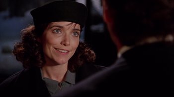 Movie still from “Scrooged” (1988), directed by Richard Donner – A woman wearing a black hat and a black jacket; Close Up shot, Over the shoulder angle