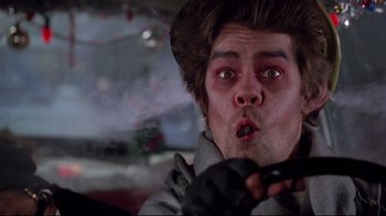 Movie still from “Scrooged” (1988), directed by Richard Donner – A person holding a cell phone; Close Up shot, Low angle