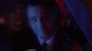 Movie still from “Scrooged” (1988), directed by Richard Donner – A person wearing a suit and tie; Close Up shot, Low angle