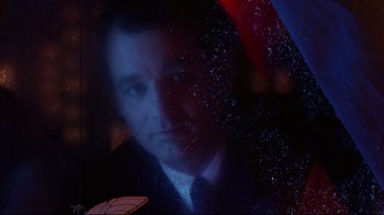 Movie still from “Scrooged” (1988), directed by Richard Donner – A person in a suit and tie; Close Up shot, Low angle