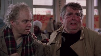 Movie still from “Scrooged” (1988), directed by Richard Donner – Two men are standing in front of each other; Close Up shot, Over the shoulder angle