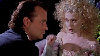 Movie still from “Scrooged” (1988), directed by Richard Donner – A man and a woman dressed up in costume; Close Up shot, Over the shoulder angle