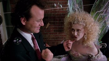 Movie still from “Scrooged” (1988), directed by Richard Donner – A man and a woman dressed up in costume; Close Up shot, Over the shoulder angle
