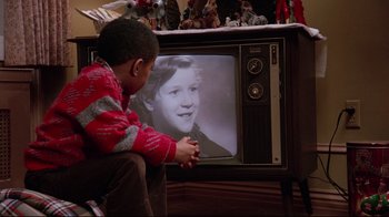 Movie still from “Scrooged” (1988), directed by Richard Donner – A young boy sitting in front of a television; Extreme Close Up shot, Over the shoulder angle