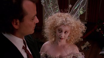 Movie still from “Scrooged” (1988), directed by Richard Donner – A man and a woman dressed up as fairy godmother; Close Up shot, Over the shoulder angle