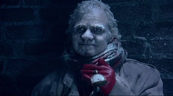 Movie still from “Scrooged” (1988), directed by Richard Donner – A man in a red scarf holding an alarm clock; Close Up shot, High angle