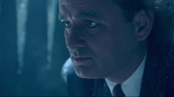 Movie still from “Scrooged” (1988), directed by Richard Donner – A person wearing a suit and tie; Close Up shot, Low angle