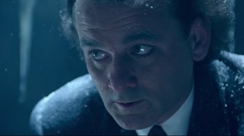 Movie still from “Scrooged” (1988), directed by Richard Donner – A person wearing a suit and tie; Close Up shot, Low angle