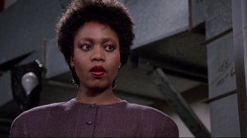 Movie still from “Scrooged” (1988), directed by Richard Donner – A black woman with red lipstick looking at the camera; Close Up shot, Low angle