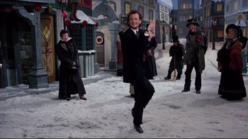 Movie still from “Scrooged” (1988), directed by Richard Donner – A group of people standing in the middle of a snowy street; Wide shot, Low angle