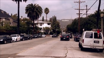 Movie still from “Searching for Sugar Man” (2012), directed by Malik Bendjelloul – Cars are driving down a street in a residential area; Extreme Wide shot, High angle